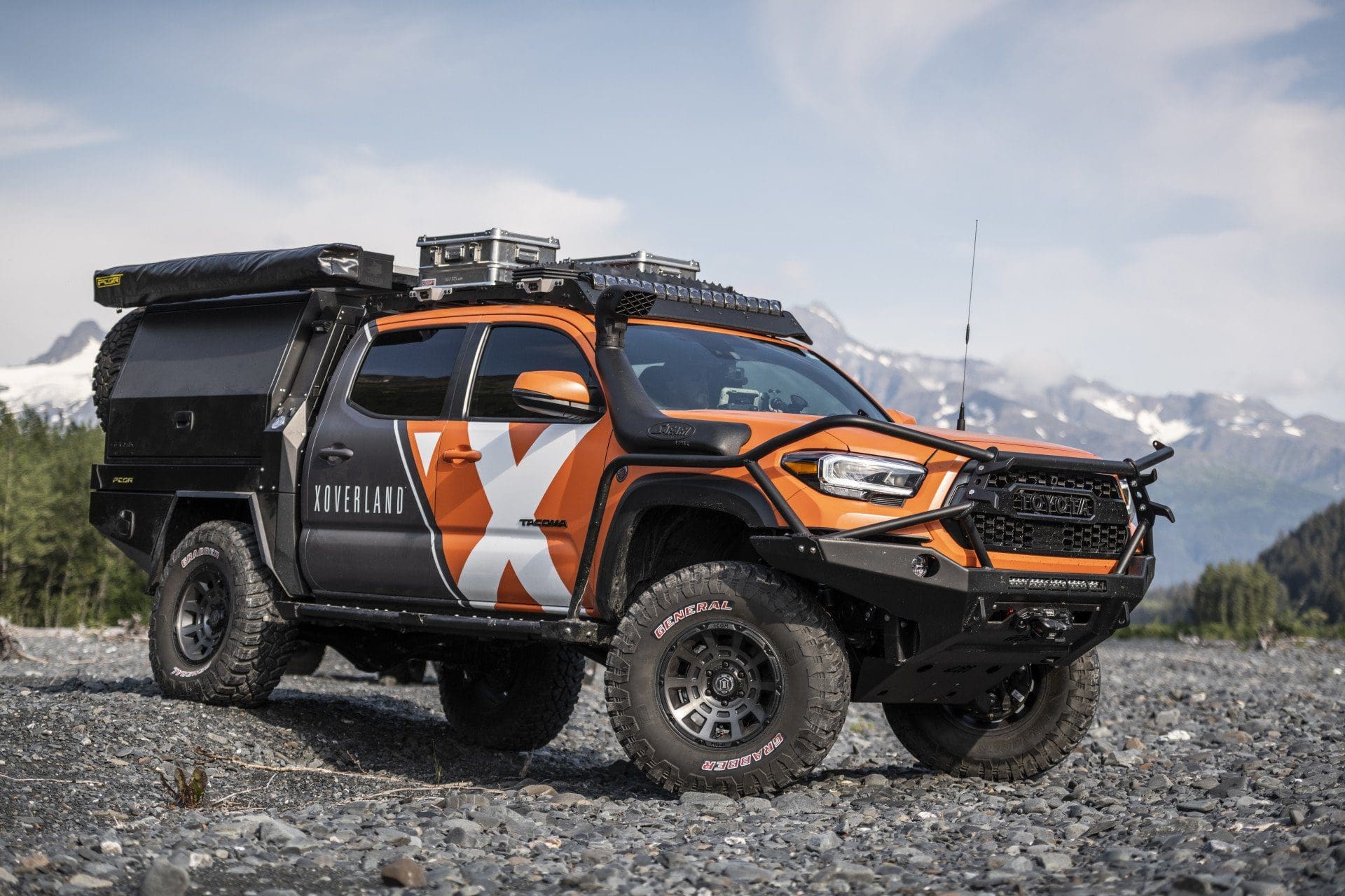 2021 Toyota Tacoma with Expedition Overland wrap in orange, black and white with large "X'